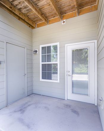 A room with a white door and window.